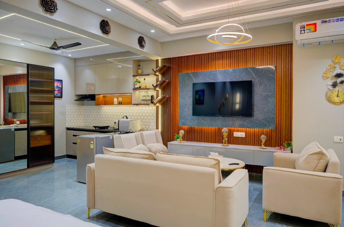 Studio kitchenette with a hexagon-tile backsplash, mini fridge and microwave beside the living area